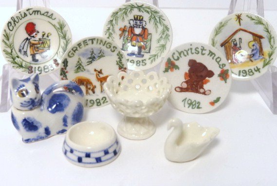 Jean Tag Christmas Plates: A set of five porcelain decorative plates for Christmases from 1982 through 1985 approx. 7/8" diameter. Also a pearl ware reticulated compote, a swan dish, a spongeware cat with removable head and a p