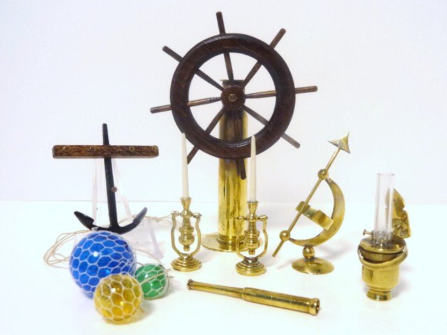 Ron Stetkowicz Marine Accessories: Generous assortment of brass, wood and metal accessories including a ship's wheel 3.5" H, anchor wall rack, an armillary, spyglass, candle stands and gimbal lamp, and a set of fisherman's glass balls 