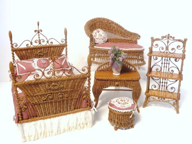 Wicker Bedroom Suite: Romantic suite of wicker furniture signed "Rhea" comprising a plumply upholstered bed 5.75" H, 5.5" L and 4.5" W, an elegant matching chaise, dressing table with stool and lovely little étagère. Wit