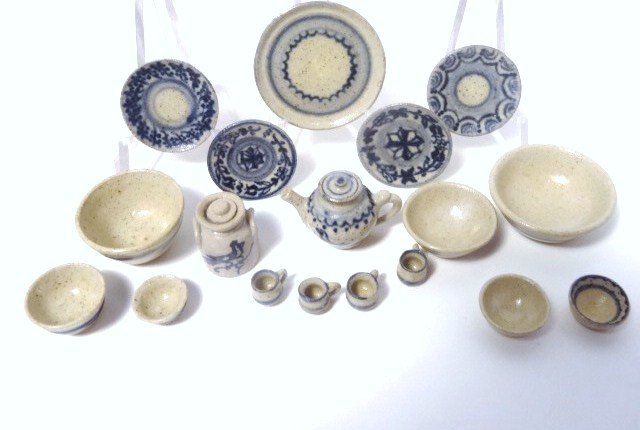 Jane Graber Pottery: Large assortment of decorated pottery by Jane Graber including two sets of graduated bowls 1/2" H, 3/4" W, four plates, a tea set and crock.