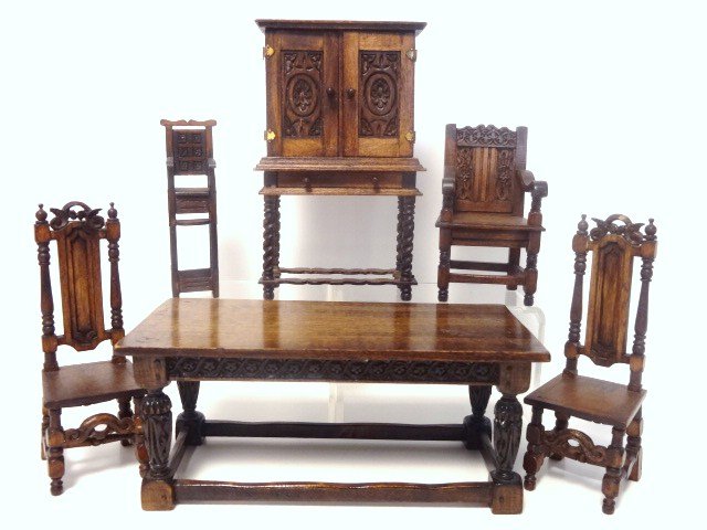 Carved Tudor Furniture: Marked CCB, an assortment of carved Tudor furniture comprising a table 2.5" H, 5.75" L, 3" W, two side chairs, a wainscot arm chair, a high chair and a press cupboard 5" H. Good quality with true char