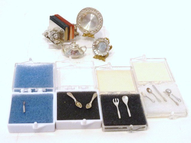 Cini Miniature Sterling and Others: Pair of Cini lion bookends w/faux books, silver ashtray, tea/coffee pot unmarked, 2 sterling teaspoons, engraved dish, silverware by Daisy Couture, tallest 1/2 in., 2 marked Cini