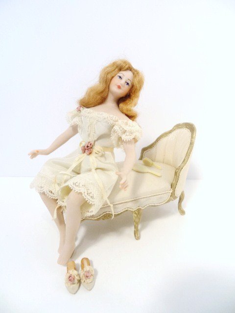 Rosemary Tucker Lady: A pretty young woman in undergarments seated on a silk upholstered chaise longue with removable slipper, brush and mirror. Just under 5" seated.