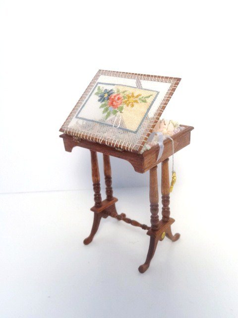 Small Ideas Embroidery Work Table: Delicate Regency lady's work table with hinged embroidery frame on top, filled with skeins of threads and partially worked petitpoint. Very fine. Roughly 4' H when opened, 2" W. By Maggie Urcioli and 