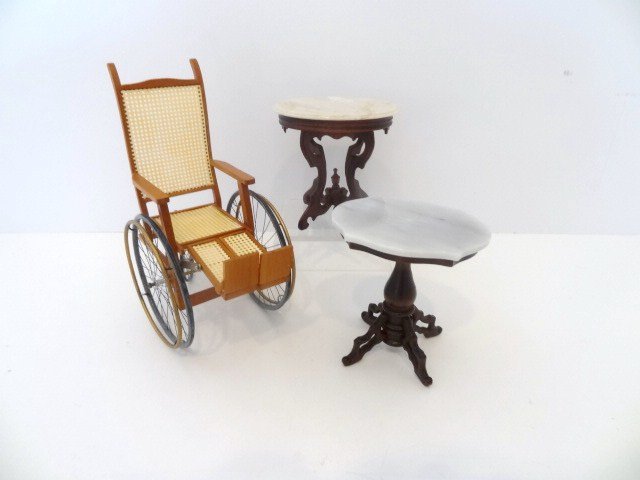 Walton Marble Table: A hand-carved Victorian marble-topped table by Nicole Walton Marble No. 12 of 25 and a Victorian pedestal table by Pat Carol, both about 2.5" H. With an old-fashioned wheelchair with adjustable foot r