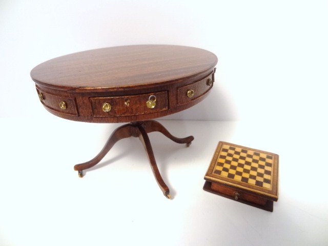 Artisan Drum Table and Chess Set: An unsigned but elegant Regency mahogany drum table with four working drawers and four false drawers, brass hardware, brass and wooden casters and nice figured tabletop 2.5" H, 3.5" diameter (one or m