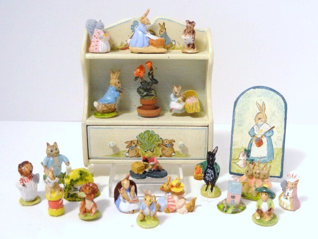 Mary Grady O'Brien Peter Rabbit Collection: Hand-painted wall shelf 2.25" H, 1.75" W and large assortment of Beatrix Potter characters and other figurines and Staffordshire cottages, etc.