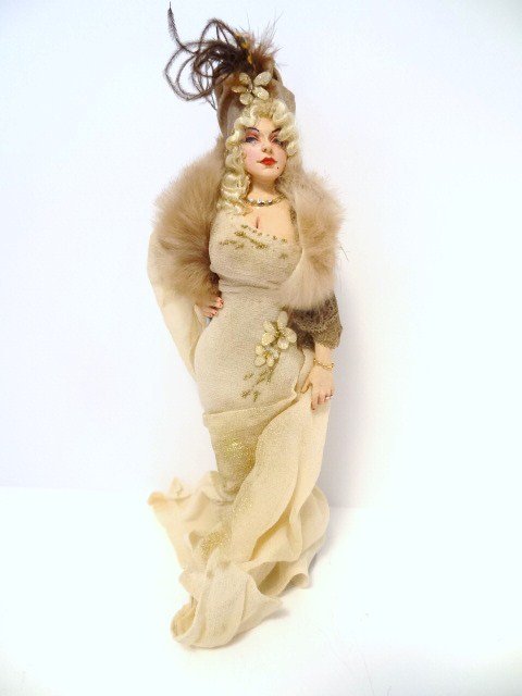 Marcia Backstrom Voluptuous Lady: In the mode of Mae West, a curvy lady in clingy dress, platinum hair with Marcel waves and projecting a confident demeanor. 6" H.