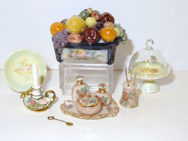 Karen Zorich Vanity Set: A feminine dresser set comprising two perfume bottle and a covered powder bowl on a tray 1" L, and a hatpin stand. Also a spoon from the IGMA, a candlestick, a cake stand and covered plate marked RH a