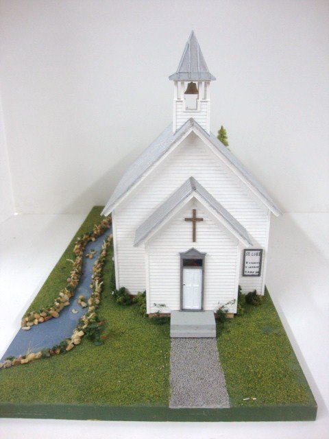 St. Luke's Church: Miniature rendering of St. Luke's Church on landscaped board with meandering stream. Interior finished with pews and pulpit, very realistic, made by Charlotte Scott. 18" x 10" x 9.5"
