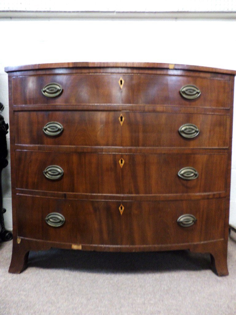 Bow Front Hepplewhite Chest: Mahogany veneer bow front chest of drawers circa 1800 w/original brasses & feet, 4 graduated drawers over flaring French feet, 40 1/2 in. (w) x 22 in. (d) x 37 in. (h)