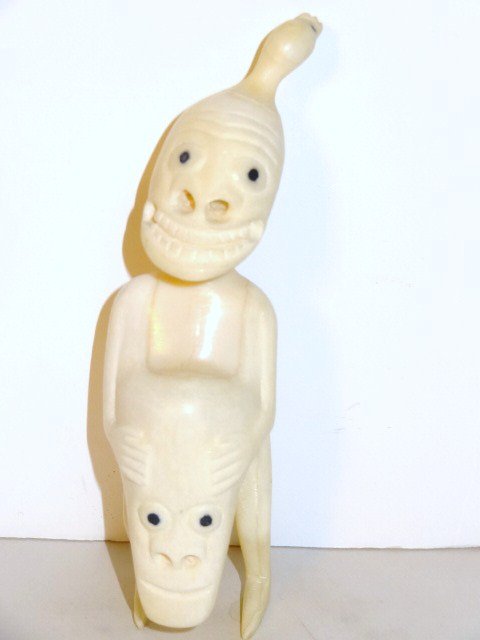 Greenland Eskimo Tupilak Carving: Carved whale tooth figure w/dyed baleen eyes, seal protruding from head, 5 in. (h)