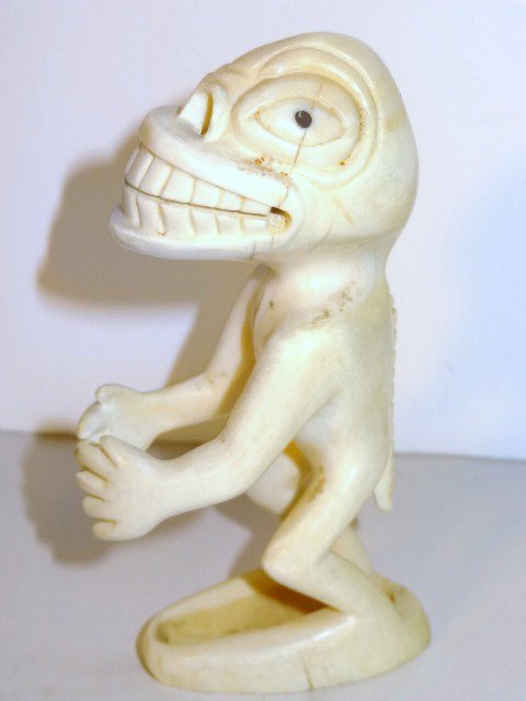 Greenland Eskimo Tupilak Carving: Whale tooth carved tupiak grotesque figure of a lizard man. w/spiny tail, 5 in. (h)