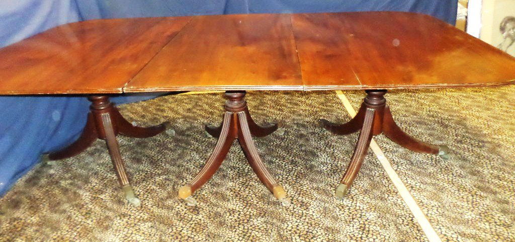 Federal Mahogany Banquet Table: Nicely figured mahogany top 64 x 53 in., includes 21 in. (w) estension & a 23 in. (h) extension, 110 in. (l) w/both extensions, includes 3 pedestal bases w/turned columns on reeded legs w/casters