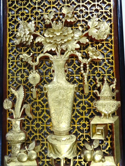 Carved Chinese Screen: Vase of flowers on table over stylized floor surrounded by vases & fruit above pierced background, double sided gilt & paint in ebonized frame 17 1/4 x 34 in. (h)
