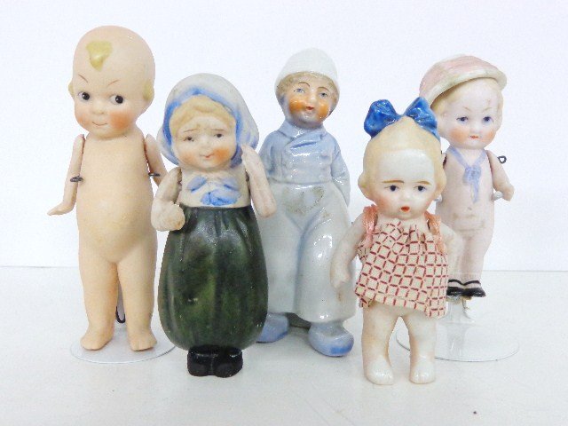 All Bisque Dolls: Japanese 3 1/2 in. original dress w/blue bow in hair, all bisque Kewpie style, Nippon all bisque w/bonnet hat, all bisque 3 1/2 in. with movable hat, all Bisque Dutch figure with basket 4 in.