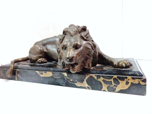 Ernest Justin Ferrand Lion Statue: Beautiful French antique circa 1900-1910, signed on extended paw Ferrand, bronze patinated metal lion on marble base, base 18 1/4 in. x 6 1/2 in., approximately 6 1/2 in. overall height
