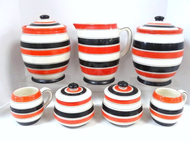 Czech Pottery Lot: Seven pcs. Erphila Czech pottery, 2 mugs 4 1/2 in., 2 - 6 in. x 6 in. canisters w/lids, 2 large canisters w/lids 10 in. (H), pitcher 8 in. (H), all striped