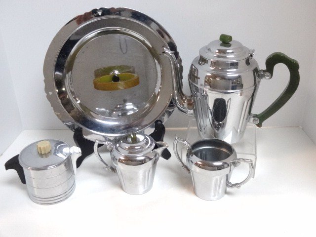 Art Deco Green Bakelite Tea Set and Others: Lot includes 5 pcs. Of art deco chrome, 3 pc. Tea set w/pot, creamer & lidded sugar, green handles, tallest 7 1/2 in., round creamer signed General Electric Hot Point w/black handle & green finial & a