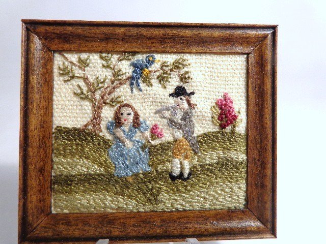 Jean Strup Embroidered Picture: A charming pastoral scene with courting couple, inspired by an 1804 sampler made by Mary LeFavour of Marblehead, MA. 2" H, 2.25" W.