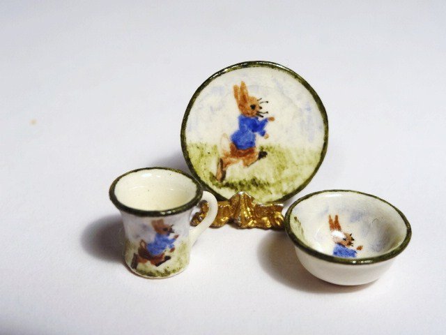 Jean Yingling Bunny China: Three matching pieces of hand-painted porcelain featuring Peter Rabbit. The cup 3/8" H.