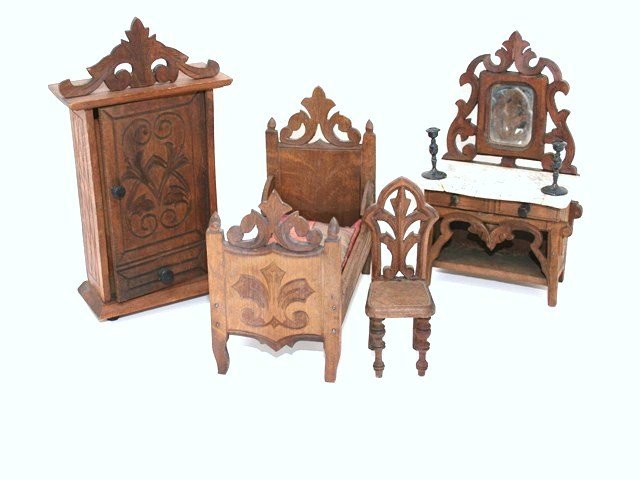 Black Forest Bedroom Suite: Utterly charming hand carved B. Harass German bedroom suite comprising a handsome armoire 7.25" H, ornately styled mirrored dressing table (knobs chipped, marble top cracked, towel bars missing), a si