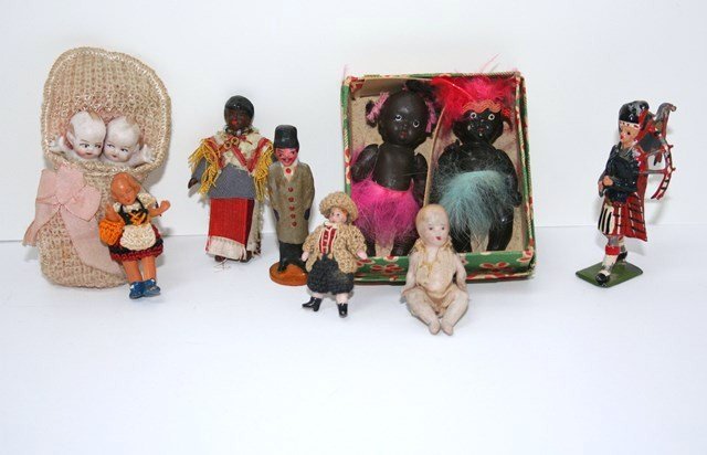 Small Dolls and Figurines: In their original box, a pair of black china bisques from Japan 2.5" H, tiny black jointed French bisques (paint rub on one face), pair of Kewpies twins in a bunting, jointed bisque baby, two tiny Fre