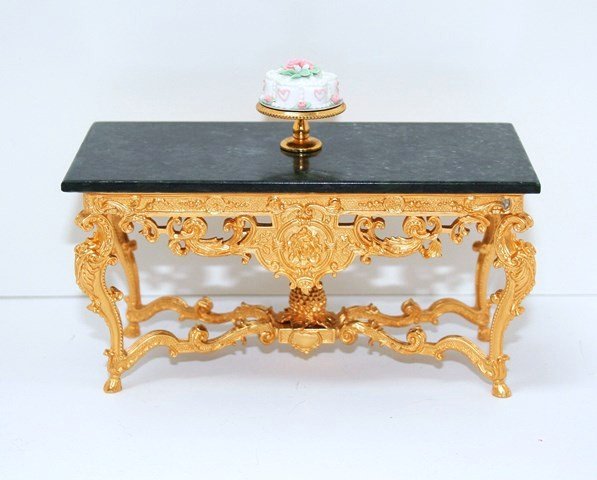 John Hodgson Console: Large gilt metal console with green/black mottled marble top 2.5" H, 5.25" W, 2.5" D. With a very pretty decorated cake on stand from The English Kitchen.