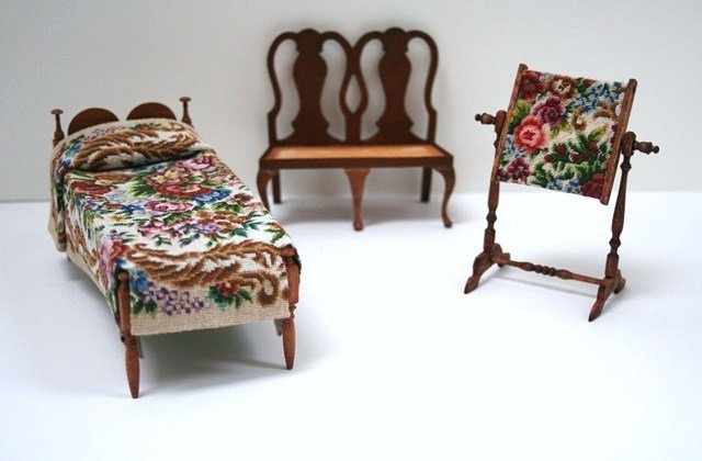 Roger Gutheil Bed: Fine petitpoint bedspread covers Roger Gutheil's cherry servant's bed with mushroom cap bedposts 2.75" H, 5.75" L, 2.5" W. Similar petitpoint on an embroidery stand and a Queen Anne settee by Linda Mi