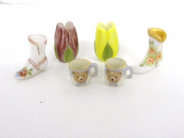 Karen Zorich Cups: Two children's cups with teddy bear faces by Karen Zorich 3/8" H, two unsigned high-button boots, and two foliate vases signed RR.