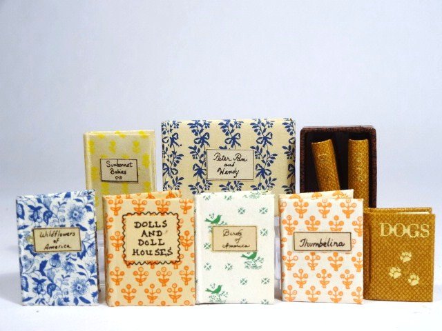 Miniature Books: Five handmade books by Amanda Epstein, Dolls and Doll Houses by Kris Huntley and a boxed three-volume set of Dogs by Mosaic Press 1" H.