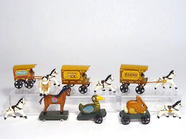Robert Street Toys: Three horse-drawn wagons 2" L, a jointed peg wooden doll, three pull toys (two missing wheels) and two extra horses.