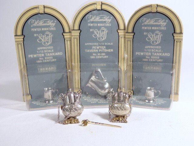 Sterling and Pewter Miniatures: Two British sterling purses 3/4" H, a silver candle snuffer and three pewter items made by Stieff for Colonial Williamsburg: two tankards and a pitcher 7/8" H, in original packaging.