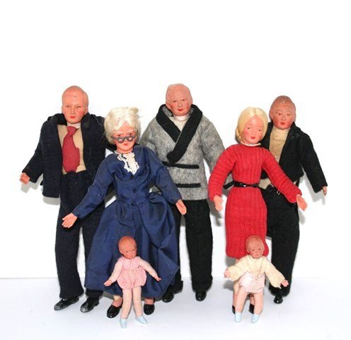 Seven Vintage Caco Dolls: Five adult and two small toddlers dolls. The two ladies are wigged, the men's suits show some wear and loss, all have great early 20th century character faces. Tallest 6" H.