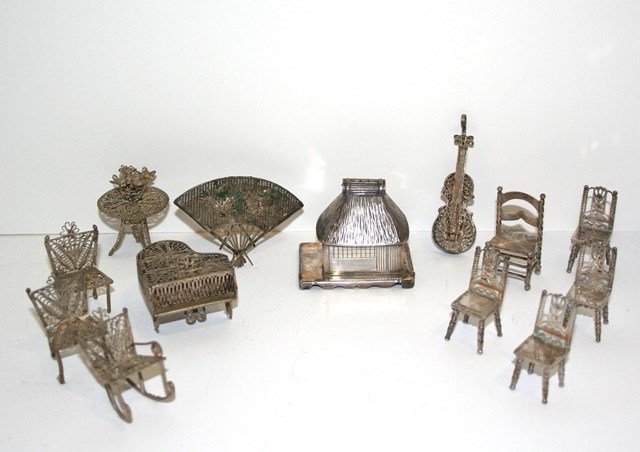 Silver Filigree Furniture: Generous assortment of silver wire filigree furniture including a charming piano 1.5" W, table chairs, fan and violin. Also a thatched roof Asian hut marked 950 Silver, and five additional small silve
