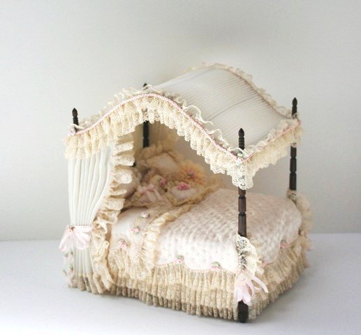 Nellie Belt - Judee Williamson Bed: An exquisite arched canopy bed constructed by Nellie Belt then breathtakingly upholstered by Judee' Williamson with quilted satin bedspread trimmed with lace and ribbon roses. Nothing but sweet dreams
