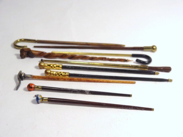 The Cane Mutiny: An assortment of fine artisan canes and walking sticks, ten in total, 3.25" H. Some adhesive residue.