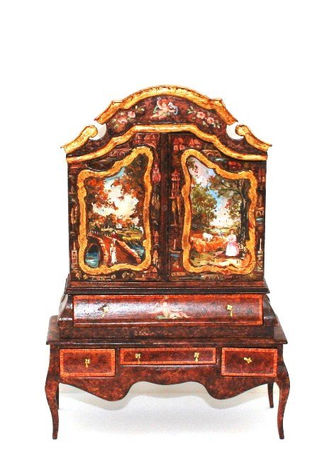 Renee Isabelle Flemish Cabinet: Decorated with a mixture of faux-grained walnut, satinwood inlay and scenic panels, a bonnet-top cabinet 7.5" H, 5 and 1/8" W with two doors opening to reveal three shelves and a faux drawer that drop