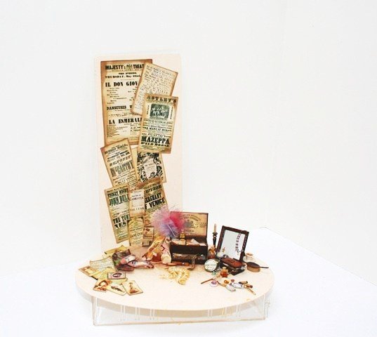 Rosie Duck Actress' Dressing Table: A richly detailed assemblage of stage actress's tools of the trade including make-up, false ringlets, costume accessories and miniaturized photographs of Sarah Bernhardt. Also a card of theatrical bro