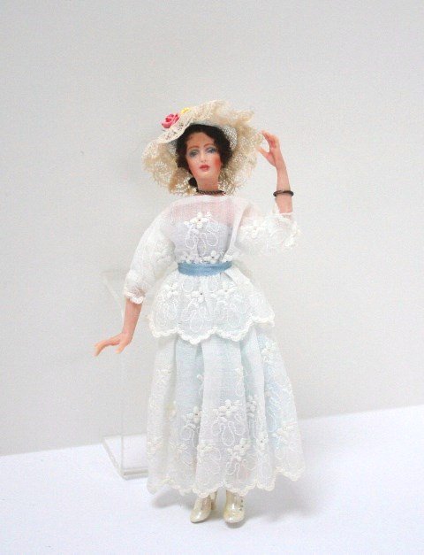 Janet Middlebrook Lady: An ethereal porcelain bisque lady in white embroidered garden party dress and pearly lustre boots adjusting her pretty hat, right out of a Merchant Ivory film. Just over 5.5" H.