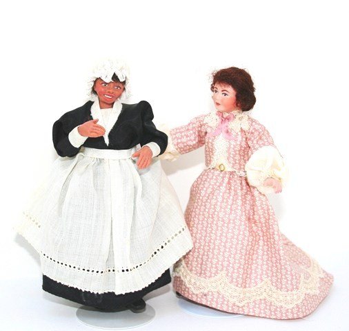 Two Victorian Ladies: A bisque lady in elaborately detailed dress with train 5.25" H, and a hand-sculpted character maid dressed in antique fabric, unsigned but possibly by Glenda Hooker.