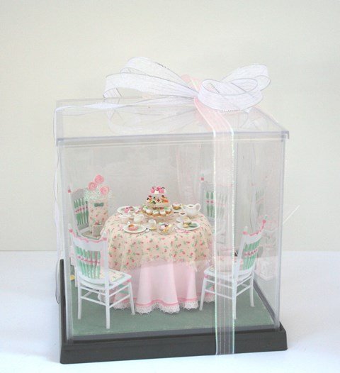 Party Luncheon Centerpiece: By the same artist as the previous lot, tea for four with elegantly decorated table and chairs, accessorized with gift-wrapped boxes and delicious pastries, 7.75" H, 7.5" W and L.