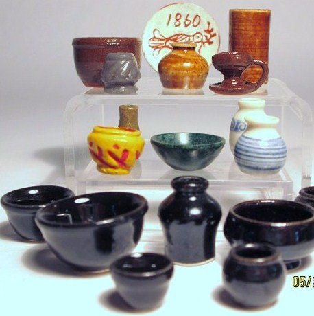 Carolyn Curran Pottery: Pitchers, bowls and crocks by Carolyn Nygren Curran with a sgraffito plate 1" D. Also a bowl and vase made of carved verdite by another artist.