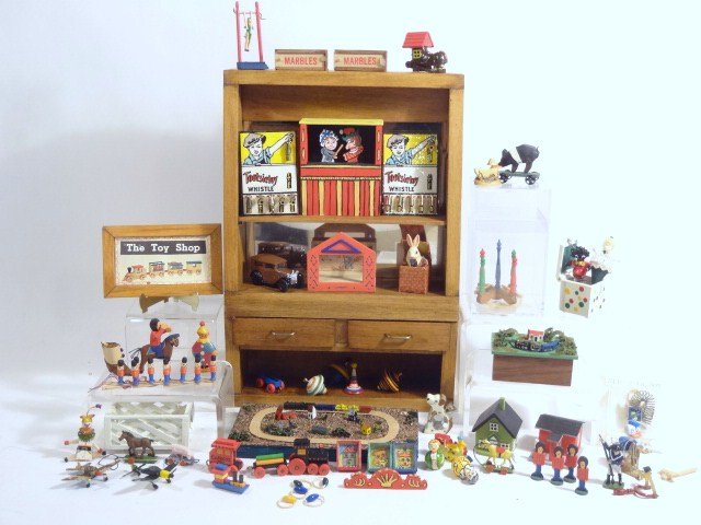 Trains, Planes and…Stuff: Miniature model railroads, toy soldiers, jack-in-the-box, roly-poly, tin whistles, some items are by David Krupick including a Punch and Judy theatre 2.25" H. Also a display case 7.5" H.