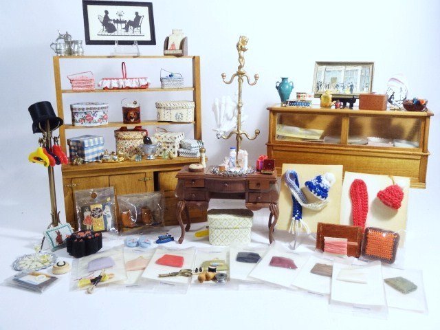 Purses and Parasols: Ladies' purses, hatboxes, hankies and other items from the dressmakers with two shop cabinets, a Block House dressing table, perfumes, ribbons, etc. Brass coat rack 5.5" H.