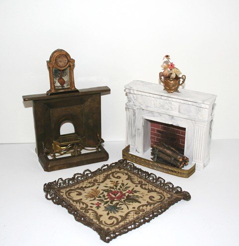 Antique Brass Fireplace: A stamped brass fireplace with gilt metal grate 4" H, 5" W with a very nice antique brass fender, offered with a small tapestry carpet, German gilt metal clock and gilt metal vase of bedraggled flower