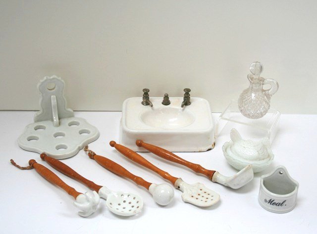 Antique German Kitchen Utensils: Sweet assortment of items for a larger scale kitchen comprising an American enameled cast iron sink 3.5" X 4.5" (chipped), a German porcelain utensil holder with five wooden-handled spoons, dippers, e
