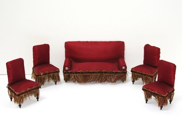 Antique Red Satin Parlor Suite: Antique German settee with red silk upholstery trimmed with unusually decorative trim 3" H, 5.25" L with four matching chairs with only the slightest wear and spotting.