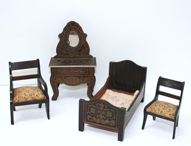 Antique Boulle Bedroom Set: Small antique German bed with gilt transfer decoration 2.75" H, 5" L with embroidered baby blanket, similarly decorated dressing table (mirror attached with table) and two chairs with flocked challis 