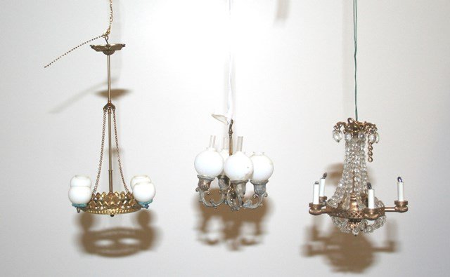 Three Antique and Vintage Chandeliers: An antique gilt metal four-arm chandelier with some paint loss and missing one chimney 2.5" L, and electrified five-arm chandelier 3" L and a four-arm chandelier with globes mounted with adhesive 4.5"